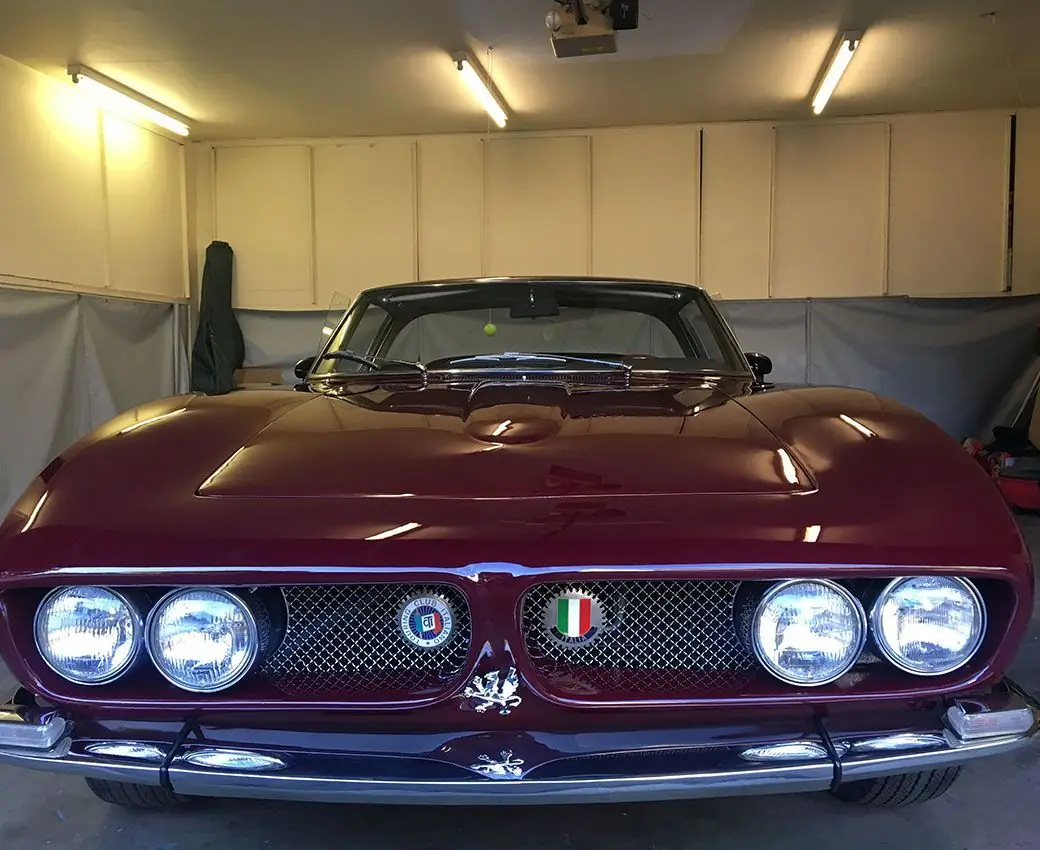 Maroon classic car detailed and preserved in the shop
