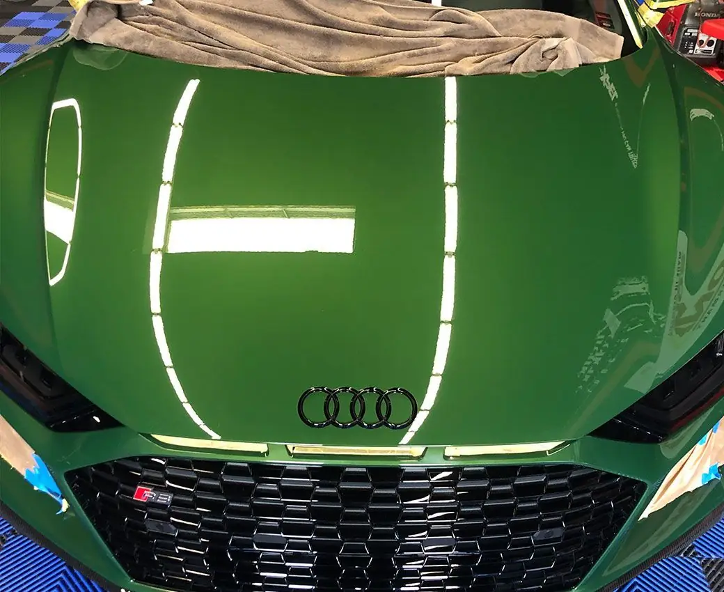 Flawless gloss on a green Audi RS hood after exterior detailing