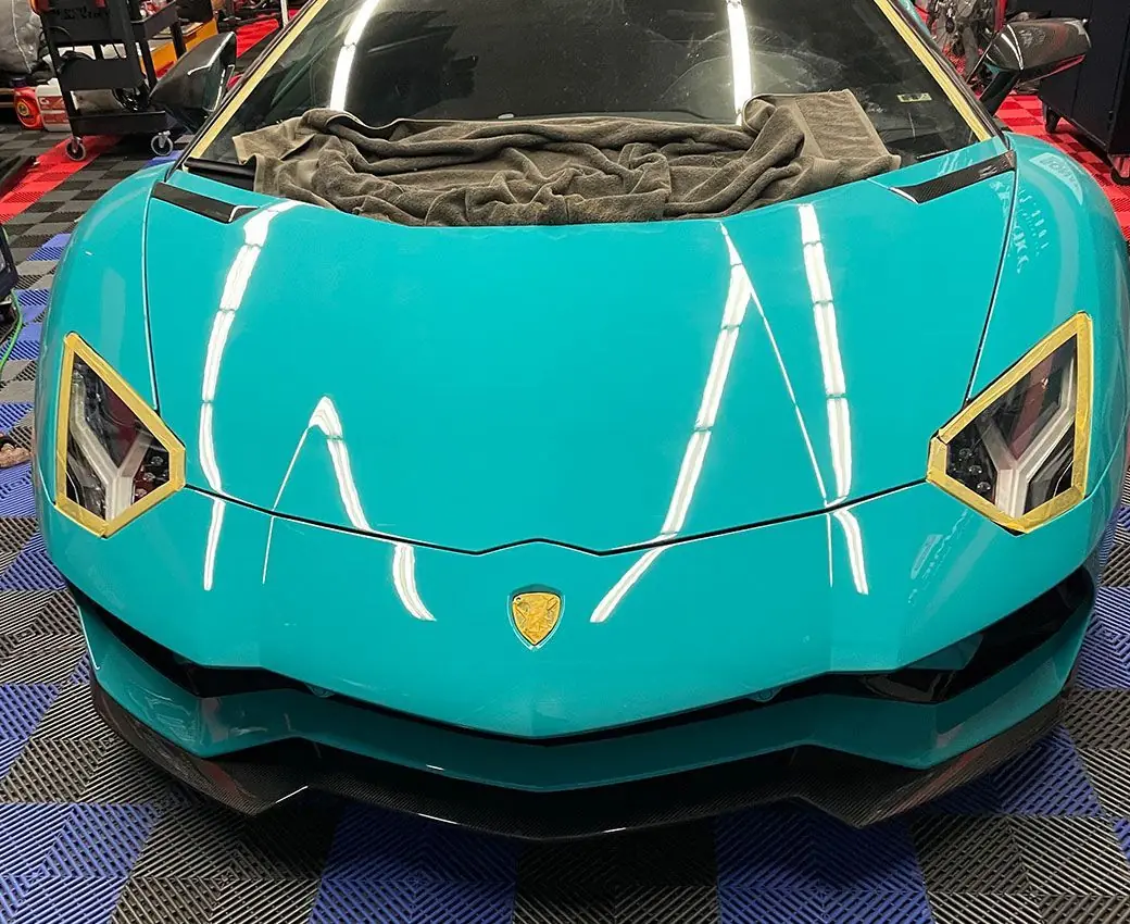 Teal Lamborghini Aventador with mirror-gloss paint after paint correction