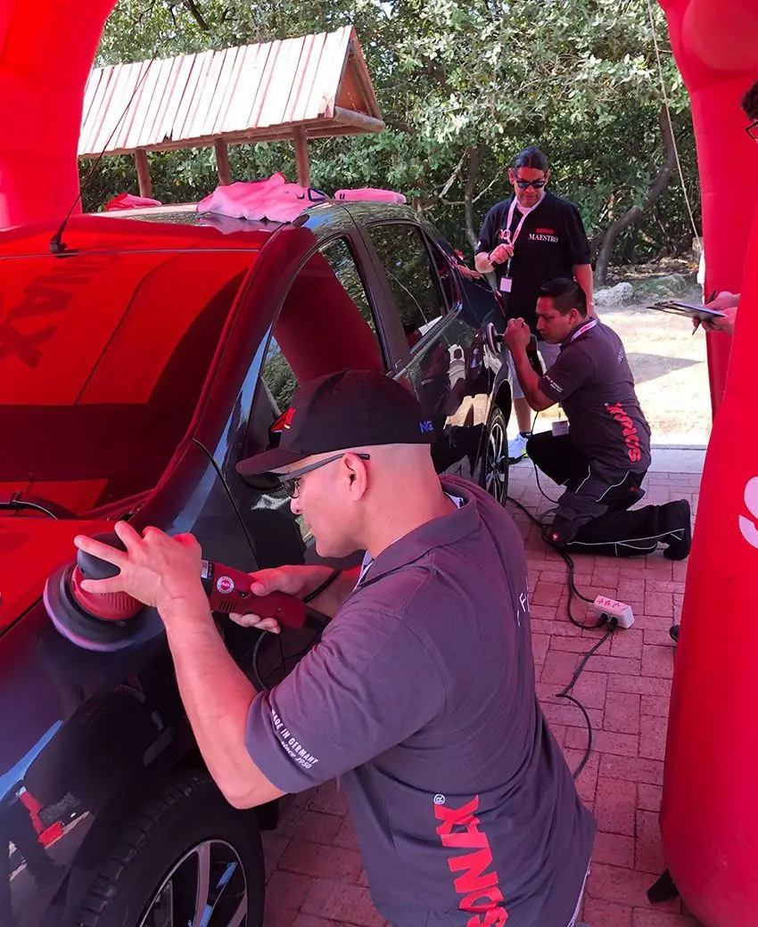 STRATA detailers polishing a vehicle at a SONAX training session