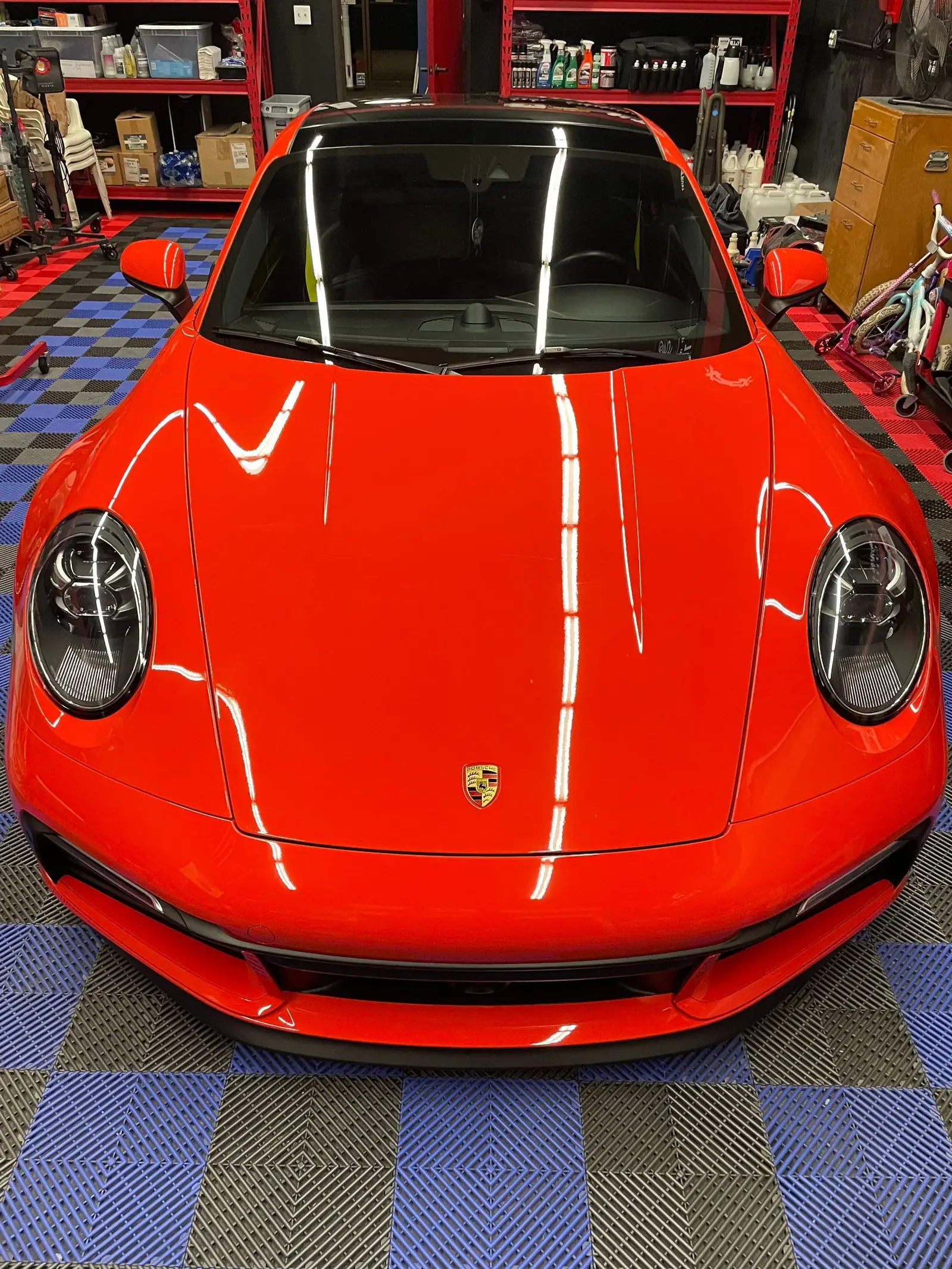 Finished red Porsche 911 in the shop before vehicle delivery