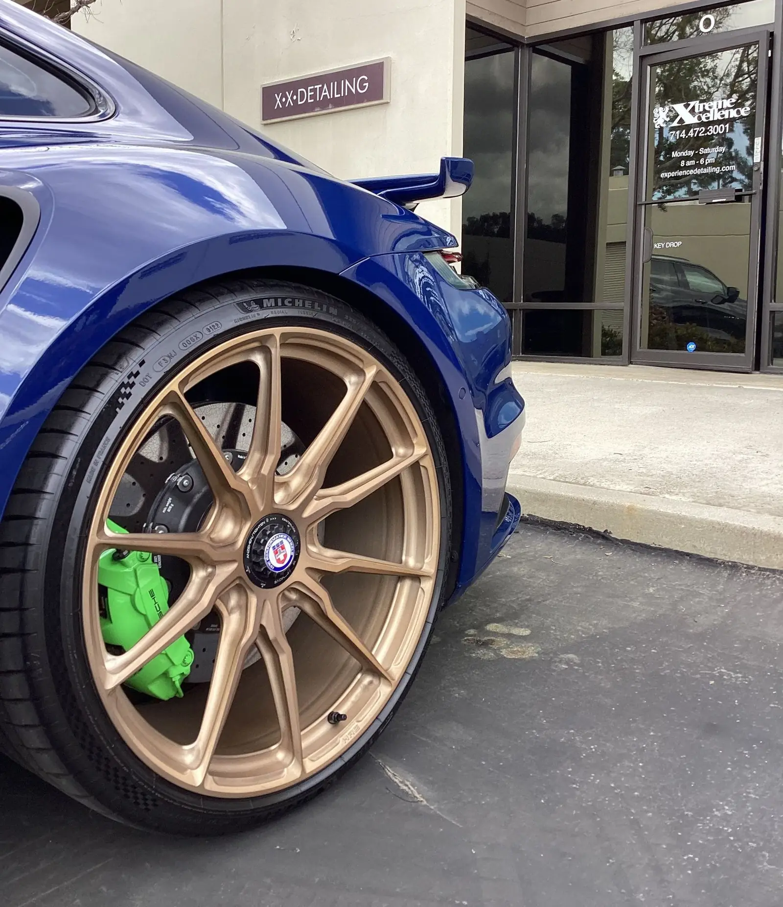Bronze wheel and gloss paintwork on a Porsche 911 Turbo S outside the shop